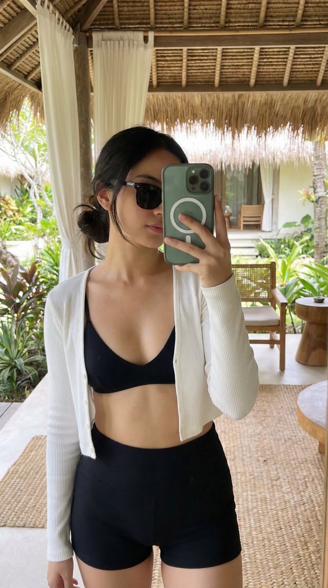{ "subject": { "description": "A slim young woman taking a tropical resort mirr…