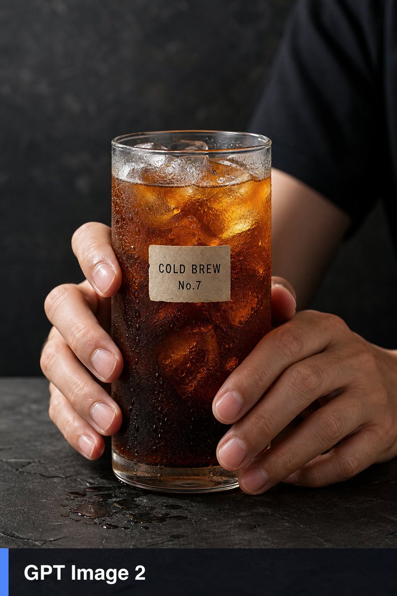 超写实工作室产品静物:两只人手握着一只高高的透明玻璃杯,杯中盛有加冰的琥珀色冷萃咖啡,玻璃杯外布满凝结的水珠,冰块折射效果逼真,五指解剖结构正确,在深色石板表面上准确呈现反射与阴…