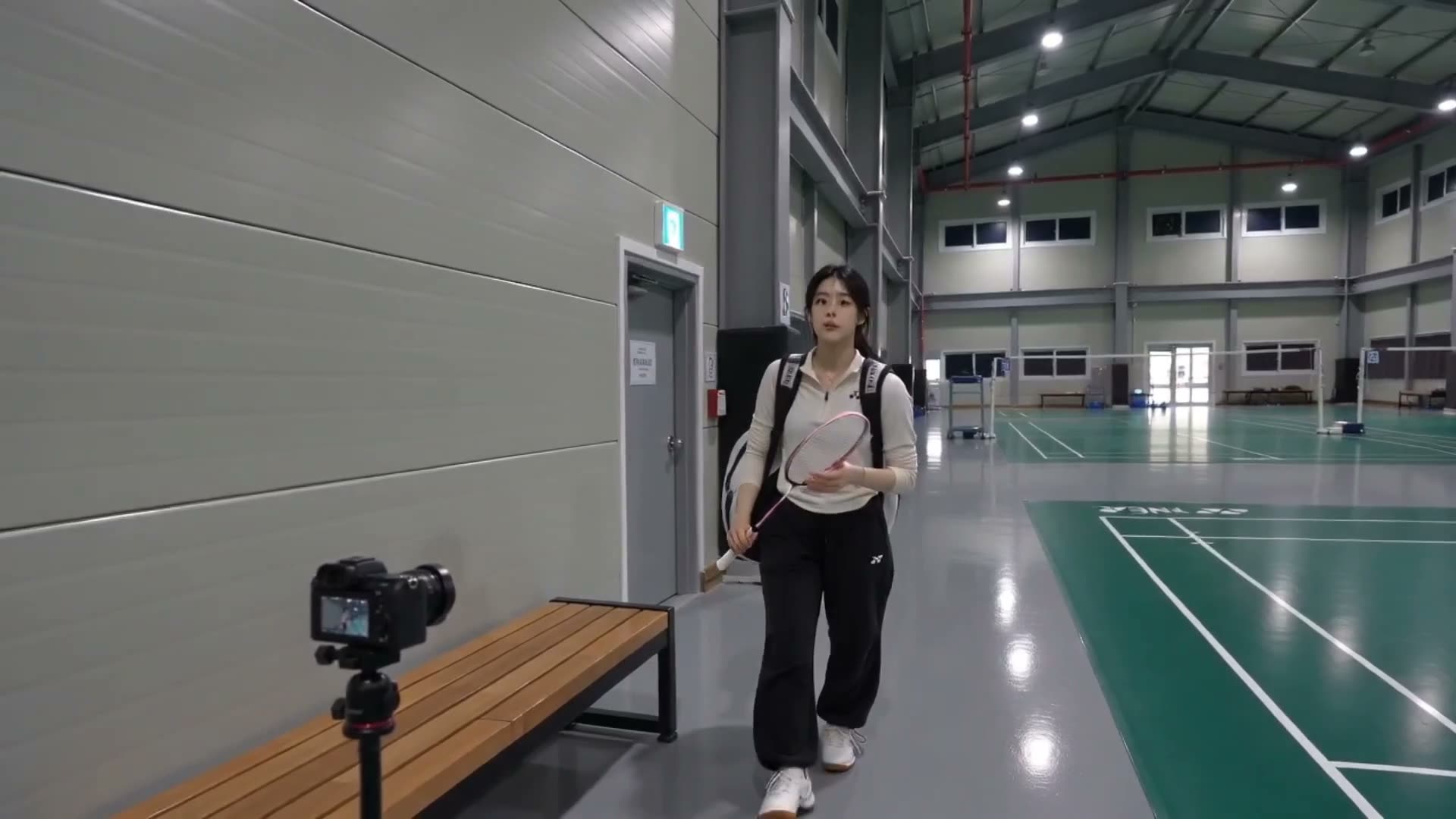 一段照片级真实感的羽毛球 Vlog，像是用 DV 16mm 手持摄像机拍摄的家用录像。手持自然抖动、柔和自动对焦、略微不完美的构图、细微的磁带颗粒、低饱和度色…