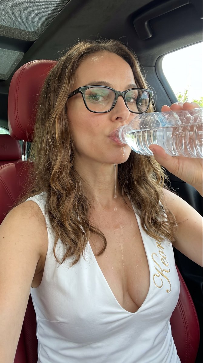 { "subject": { "description": "年轻女性 Freya Allan,肤色白皙,长长的波浪状金色头发,黑框眼镜,绿色眼影,饱满的嘴唇含着水瓶口,眼神望向…